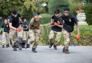 A group of young people pulling some tyres